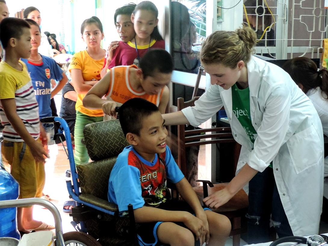A Vietnamese child is examined by a medical volunteer for a basic health check A medical volunteer in Vietnam participates in a community healthcare outreach